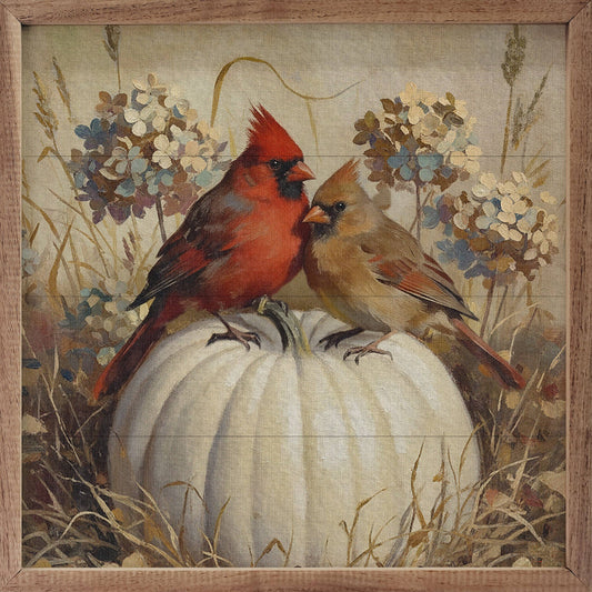 Framed painting of two cardinals perched on a white pumpkin with autumn florals