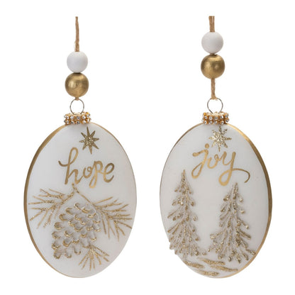 Two oval glass ornaments with gold 'Hope' and 'Joy' script, pinecone and Christmas tree designs