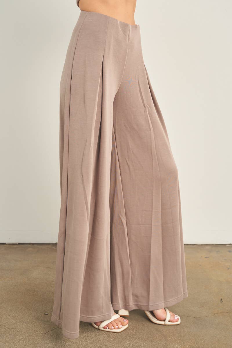 ANWND wide leg palazzo pants in taupe with pleated front and flowy silhouette