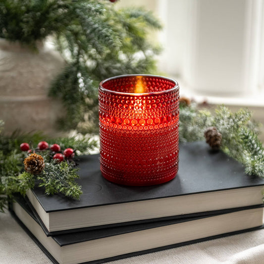 Red hobnail dotted glass flameless candle with warm glowing 3D flame effect