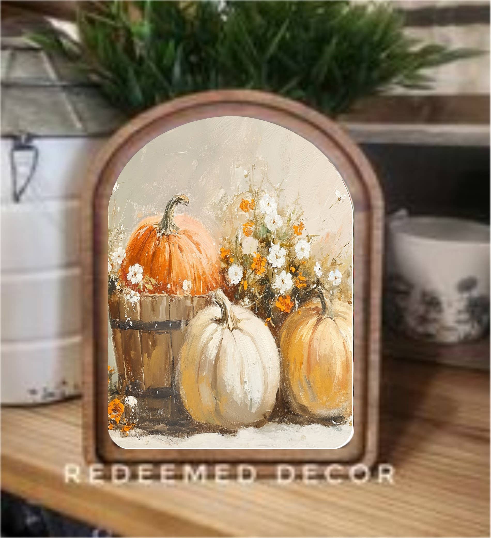 Arched wood-framed canvas art with orange, white, and gold pumpkins and wildflowers