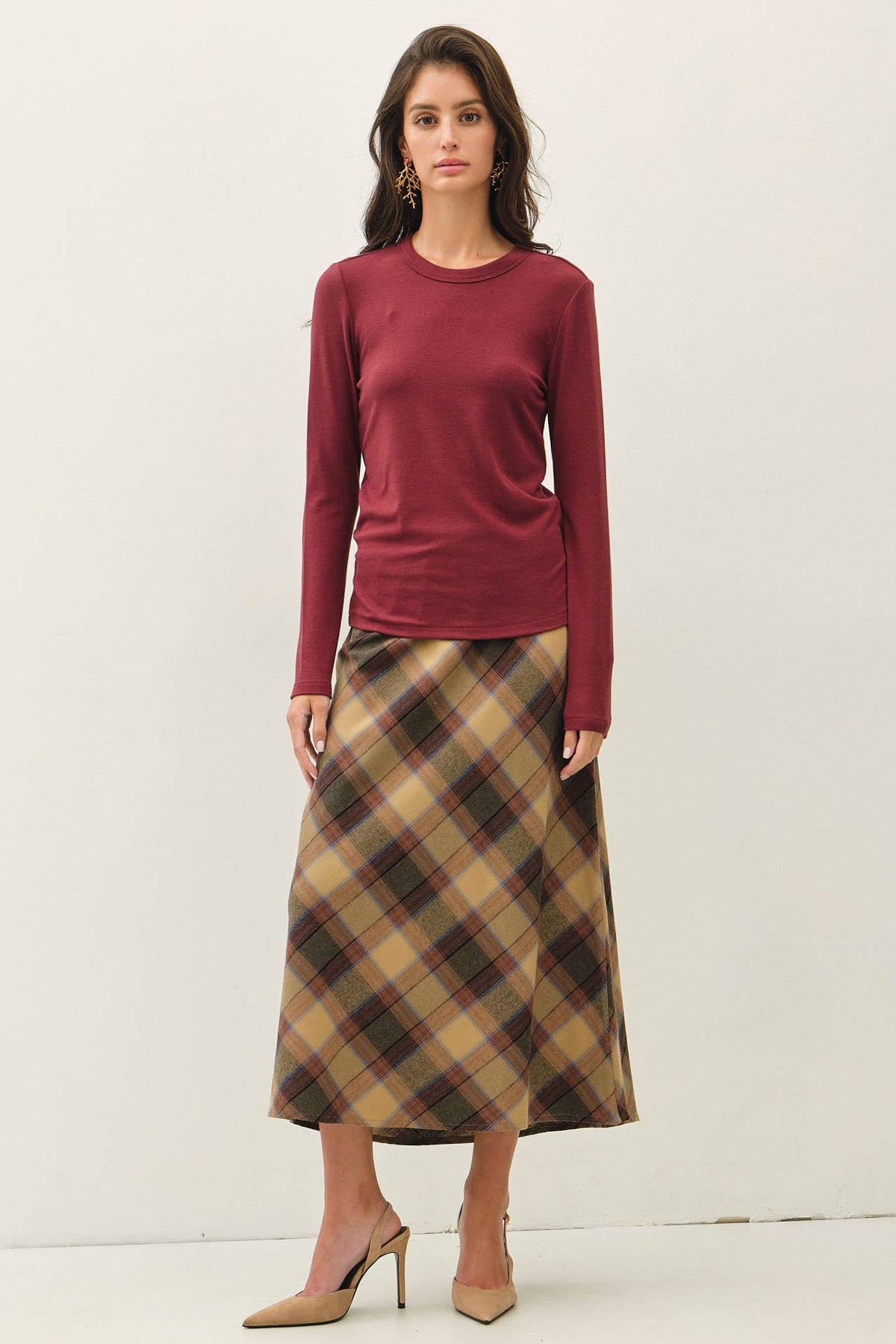 Be Cool burgundy round neck long sleeve fitted knit top worn with plaid skirt