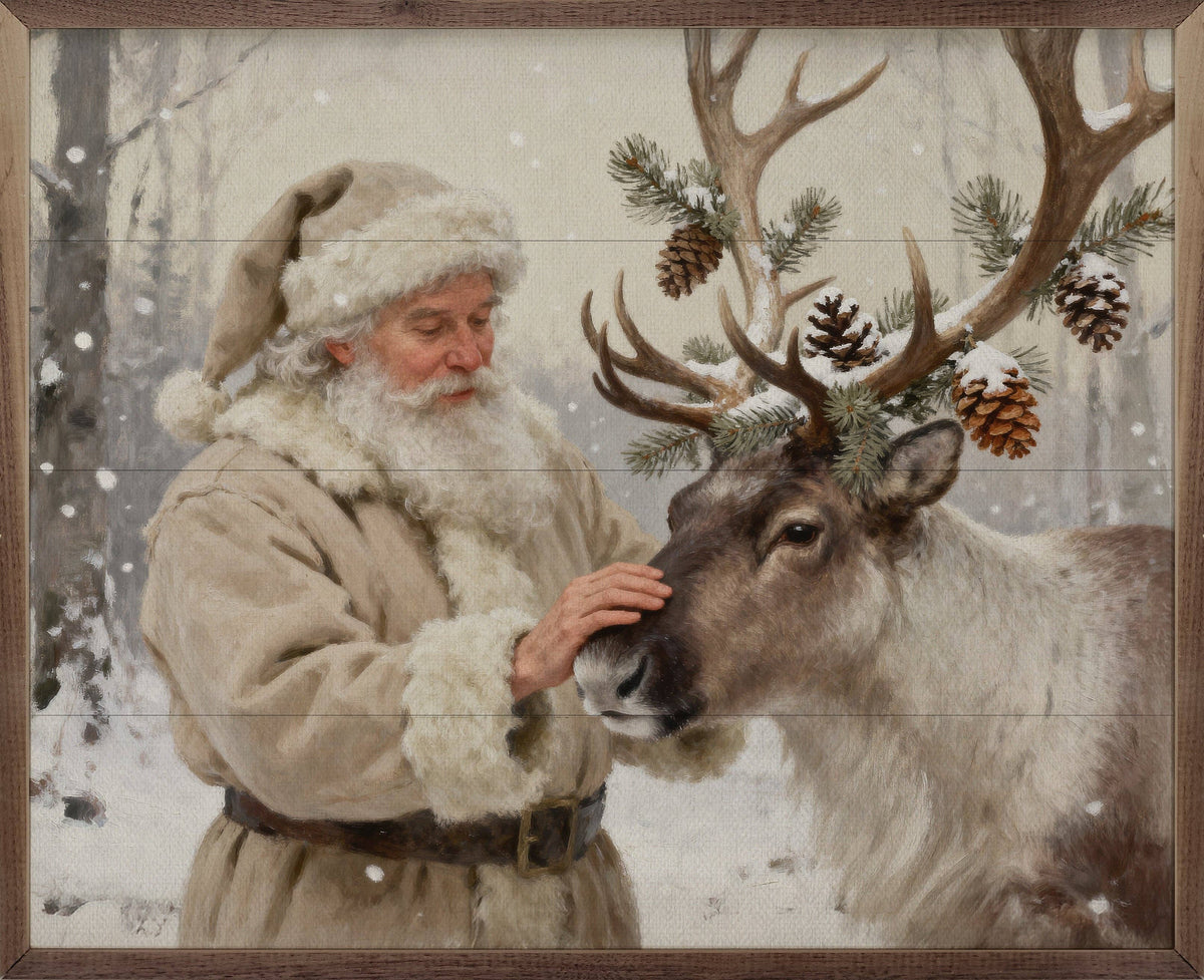 Framed oil painting of Santa in cream fur coat petting a decorated reindeer in snow