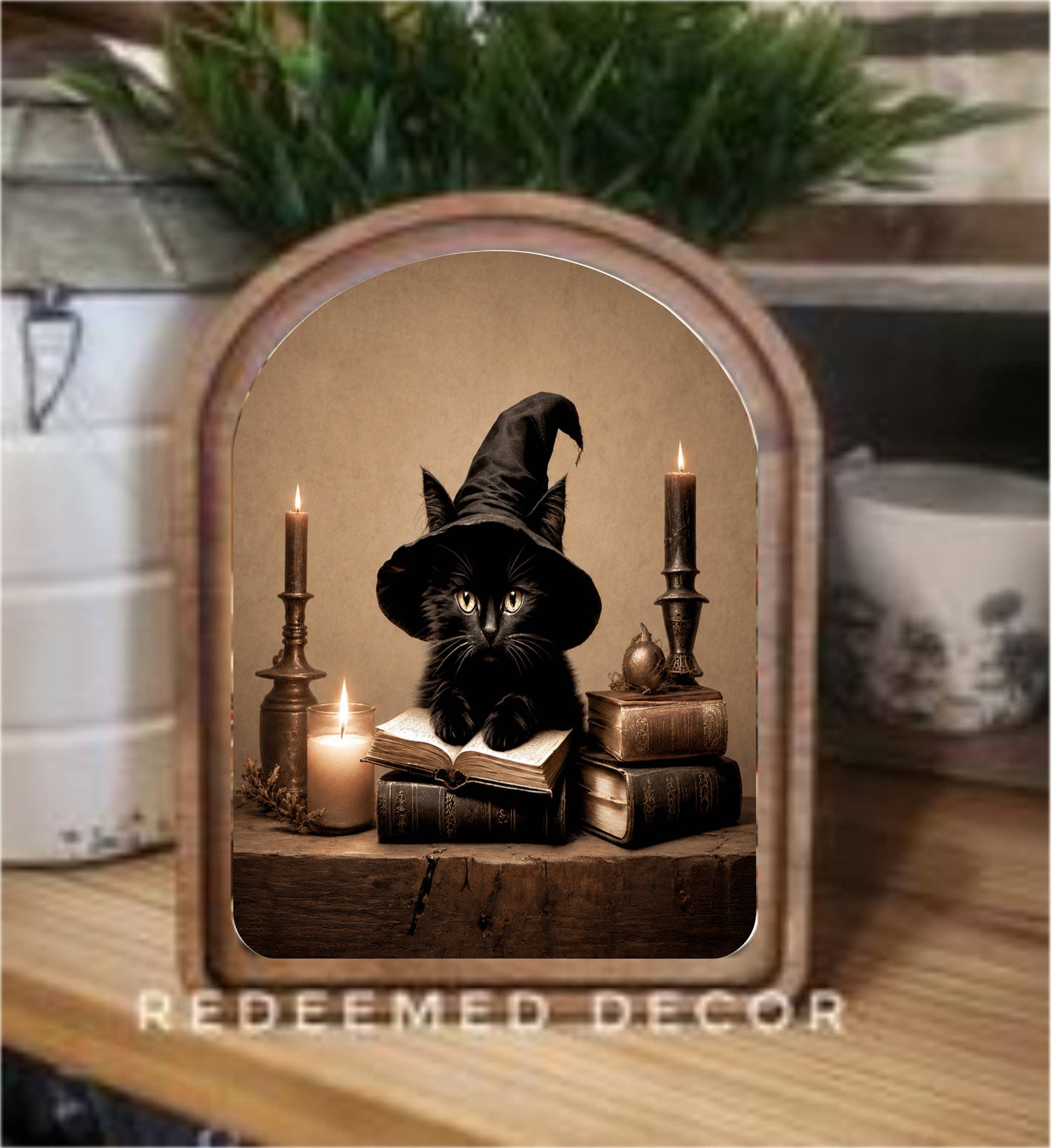 Arched wood framed canvas art of black cat in witch hat with books and candles