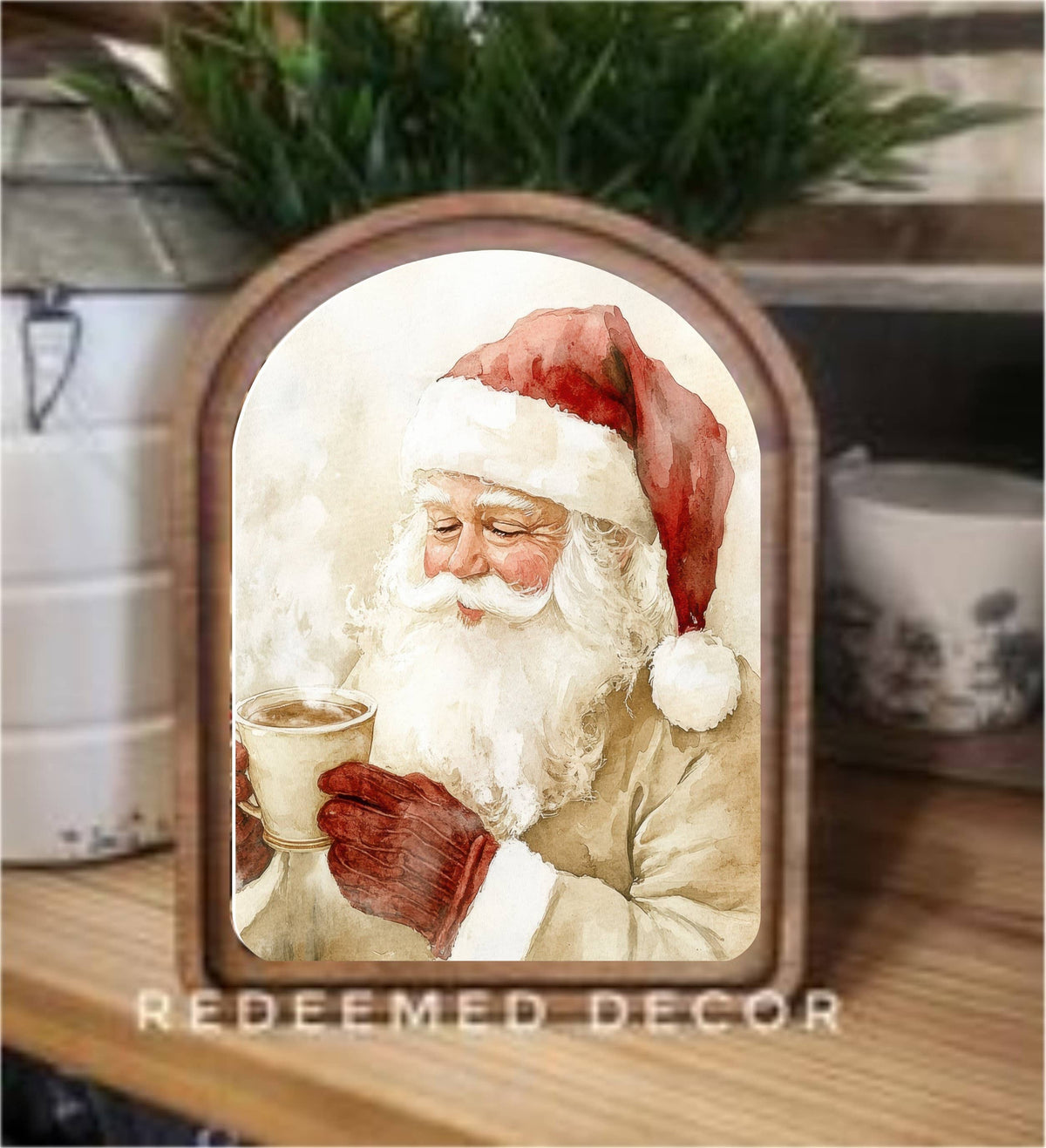 Arched wood-framed canvas art depicting vintage watercolor Santa holding steaming cocoa cup