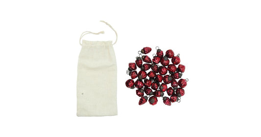 Set of 36 small red embossed mercury glass ornaments beside a drawstring muslin bag