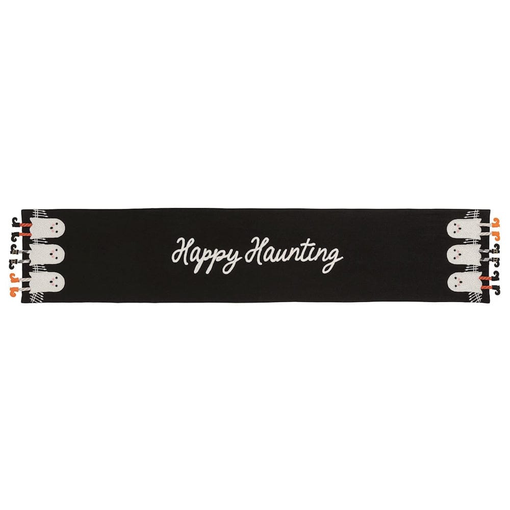Black Halloween table runner with white ghost figures and dangle legs on each end, 'Happy Haunting' script center