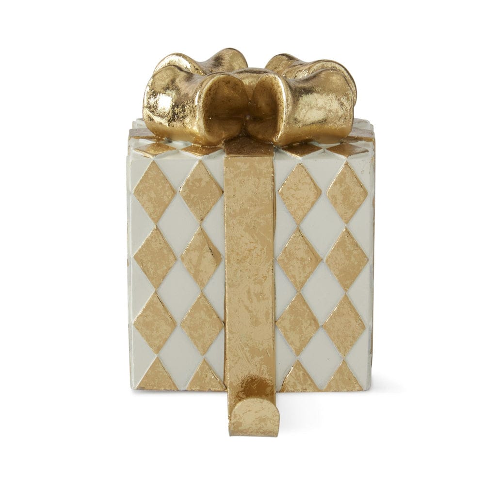 Gift box-shaped stocking holder with gold diamond pattern, decorative bow, and bottom hook