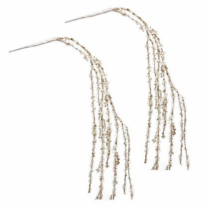 Two decorative glitter-covered branches with cascading beaded strands on white background