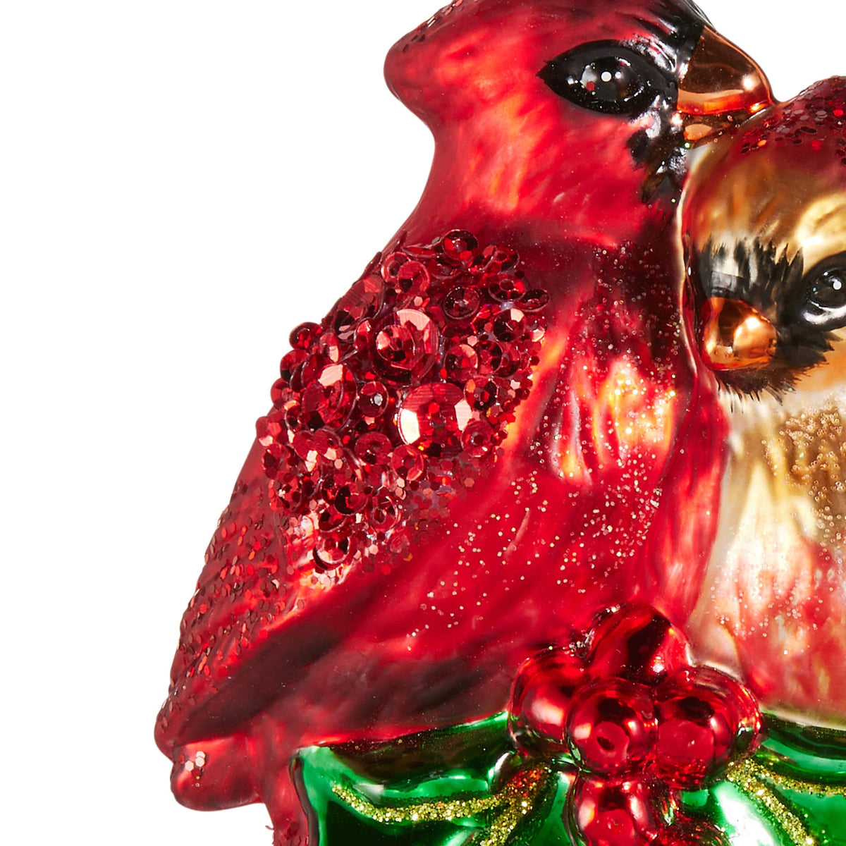 Glass cardinal pair ornament with glitter detailing perched on green holly with red berries