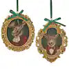 Two gold oval framed ornaments featuring deer and moose busts with green ribbon hangers