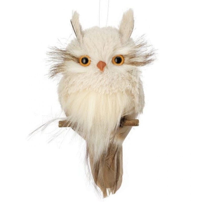 Fluffy white owl ornament with orange eyes perched on a small wooden branch, hanging string visible