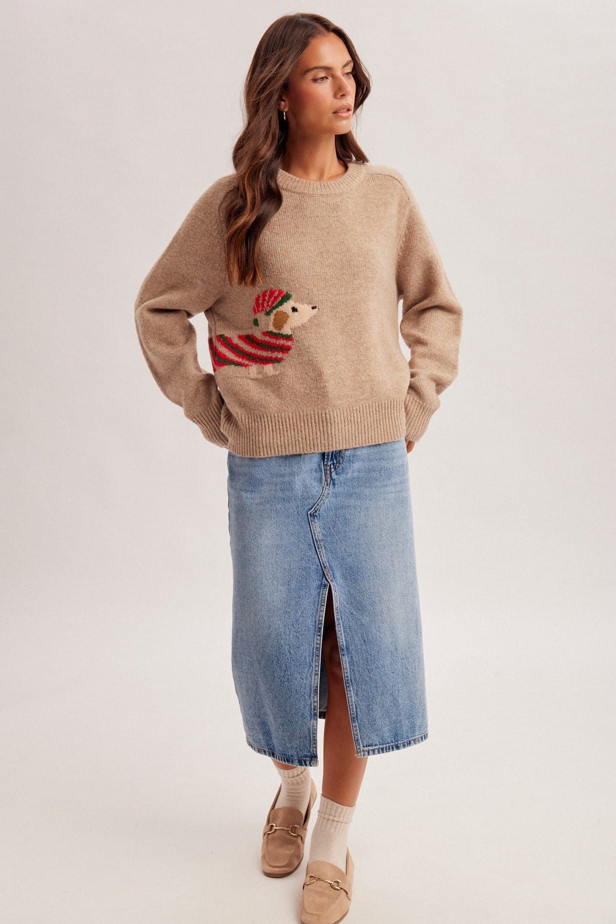 Tan knit Christmas sweater with festive dog intarsia, paired with denim midi skirt