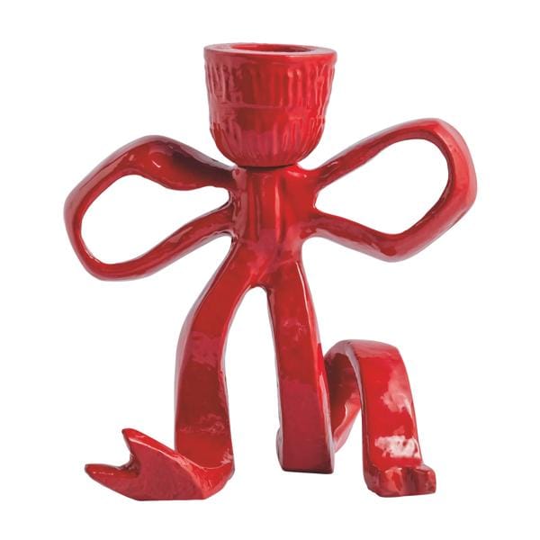 Glossy red ceramic taper candle holder shaped like a bow-tie figure with legs, front view