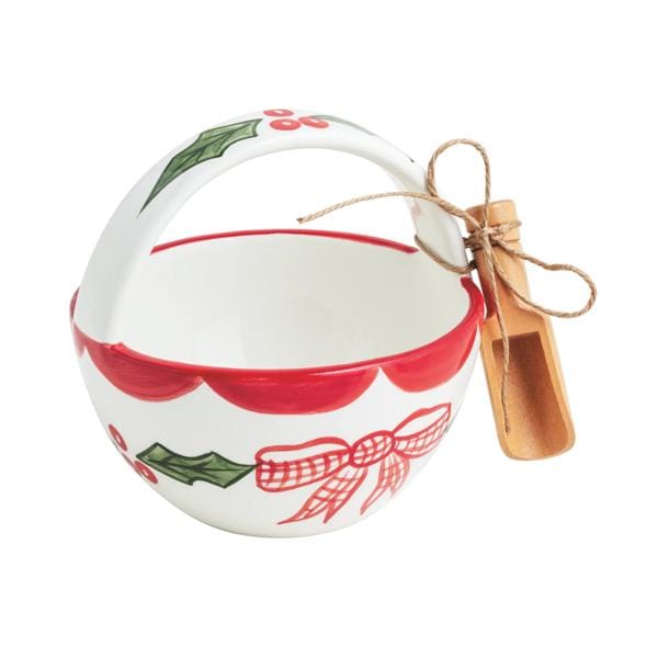 White ceramic holiday bowl with holly and bow design, wooden scoop tied with twine