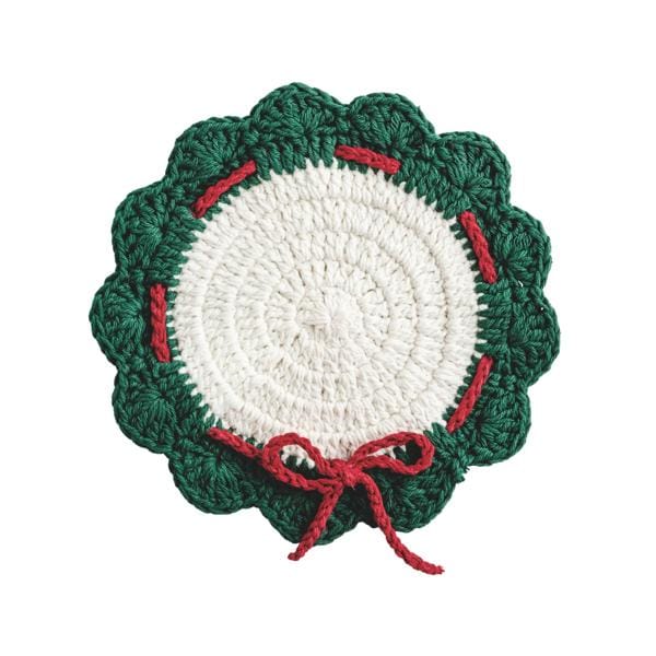 Round crocheted trivet with white center, green scalloped border, and red bow accent