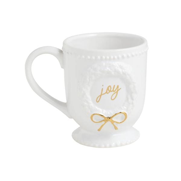 White footed ceramic mug with embossed wreath, gold 'joy' script, and gold bow detail