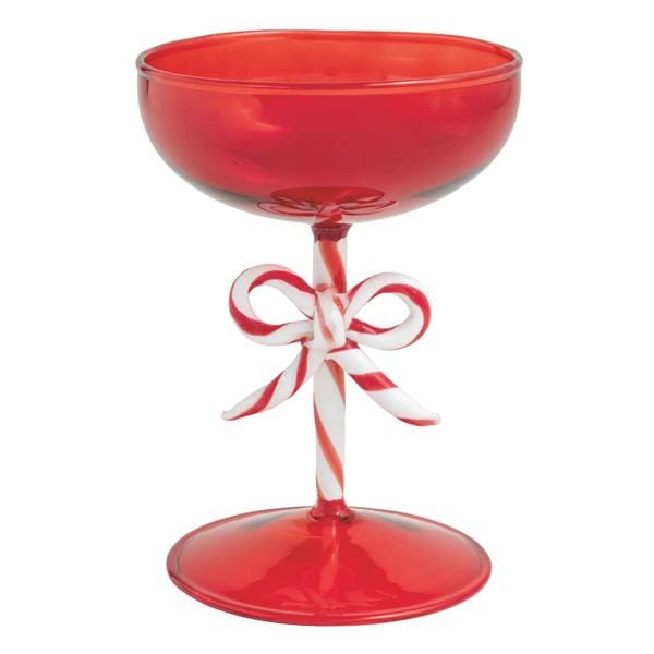 Red coupe cocktail glass with candy cane striped stem and decorative bow, front view