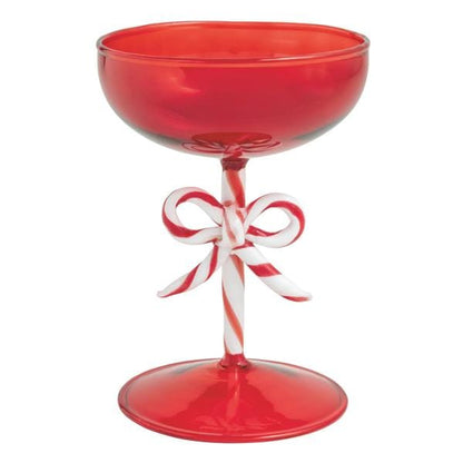 Red coupe cocktail glass with candy cane striped stem and decorative bow, front view