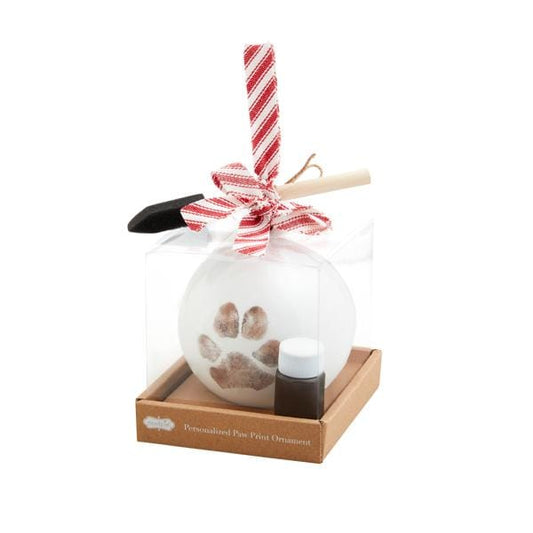 White glass Christmas ornament with brown paw print, packaged with ink and brush tools