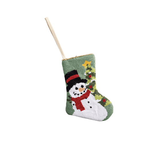 Small needlepoint Christmas stocking featuring a snowman with red scarf and black hat near a decorated tree