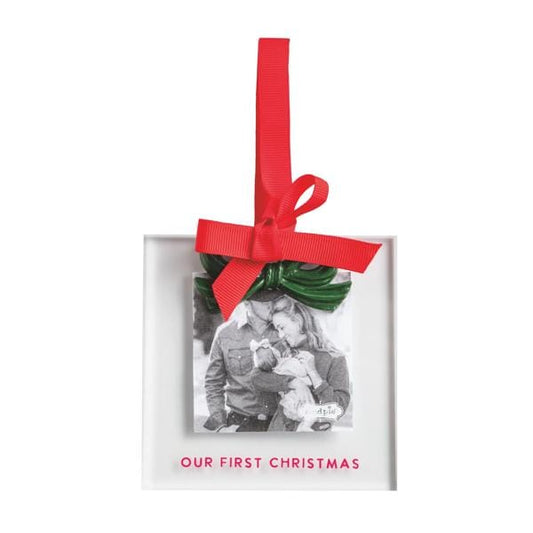 Square acrylic photo ornament frame with green bow, red ribbon, and 'Our First Christmas' text