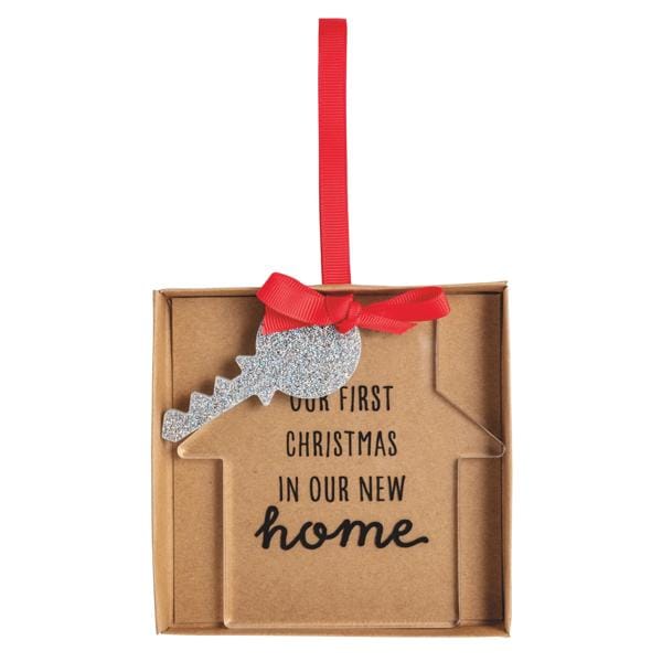 House-shaped ornament card with glitter key charm and red bow, reading 'Our First Christmas In Our New Home'