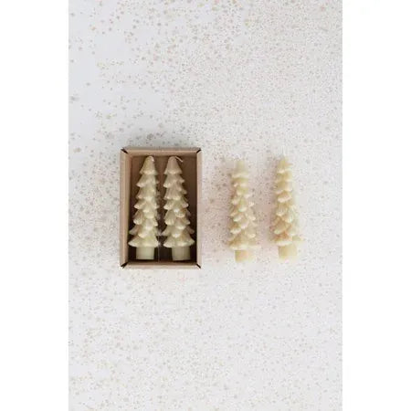 Cream tree-shaped taper candles set of two in kraft box beside two standing candles