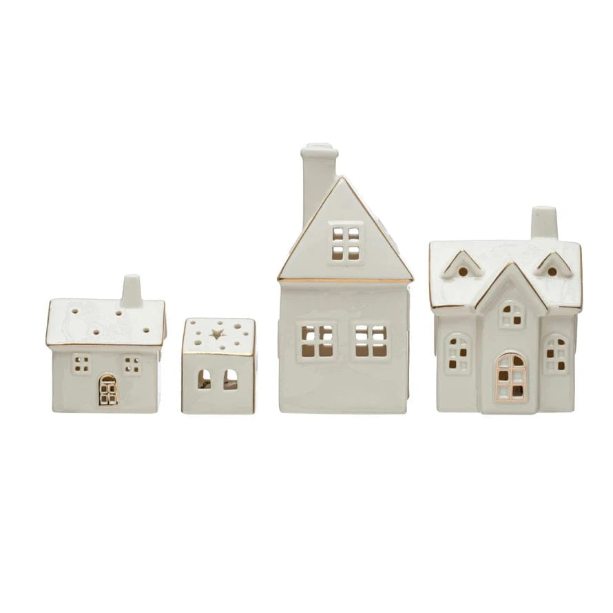 Set of four white stoneware village houses with gold trim and cutout windows