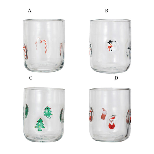 Set of 4 clear holiday drinking glasses with candy cane, snowman, Christmas tree, and Santa designs
