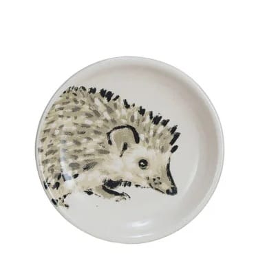 Small round white stoneware dish with black and gray hedgehog illustration