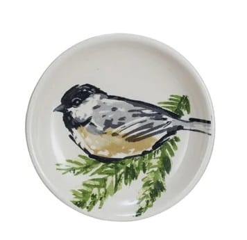 Round white stoneware dish with painted chickadee bird on green pine branch
