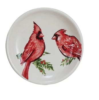 Round white stoneware dish featuring two red cardinal birds on holly branches