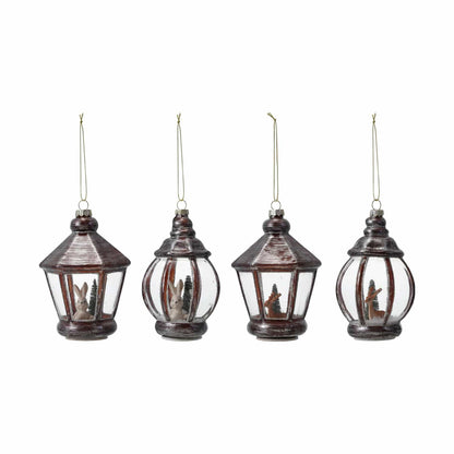 Set of four dark brown glass lantern ornaments with bunny and deer winter scenes inside