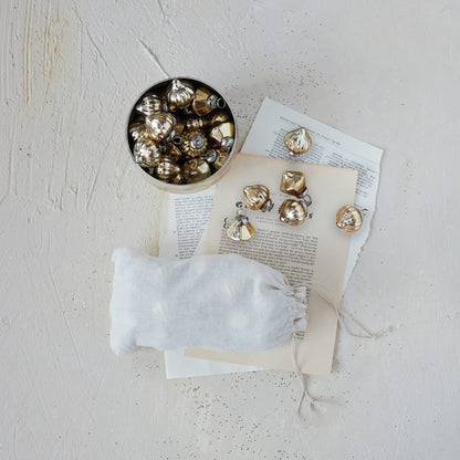Set of 36 gold mercury glass embossed ornaments in white muslin drawstring bag