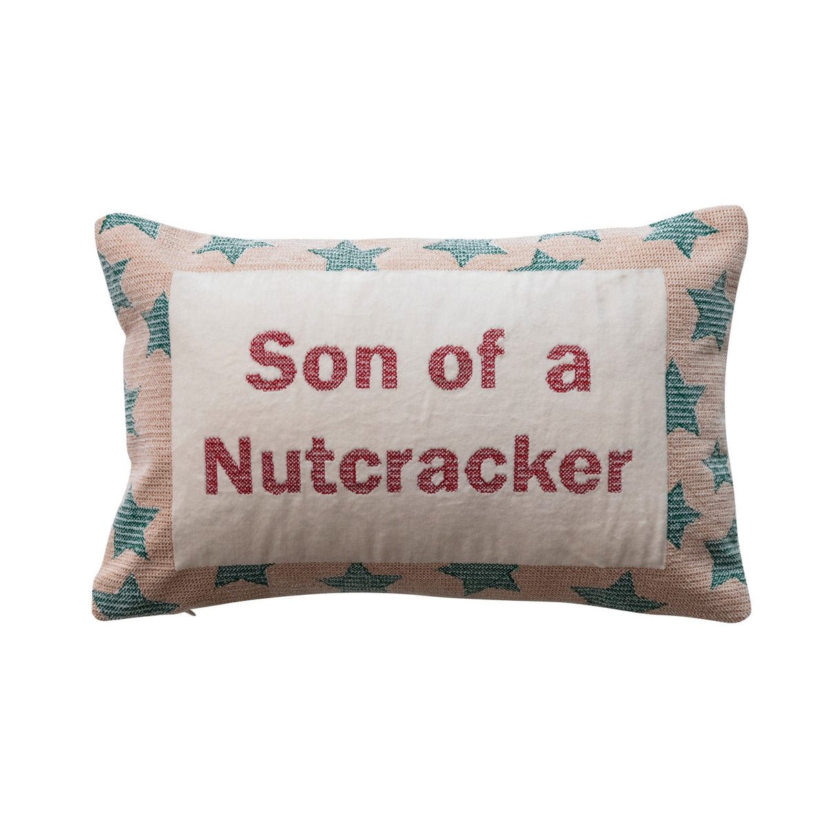 Cream lumbar pillow with red Son of a Nutcracker embroidery and teal star border