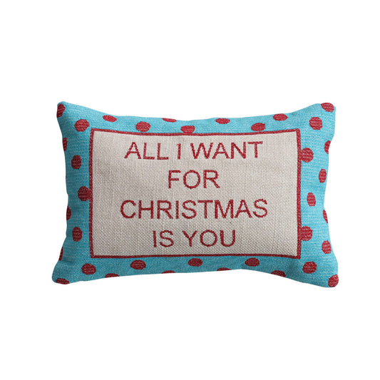 Teal lumbar pillow with red polka dots and All I Want For Christmas Is You text