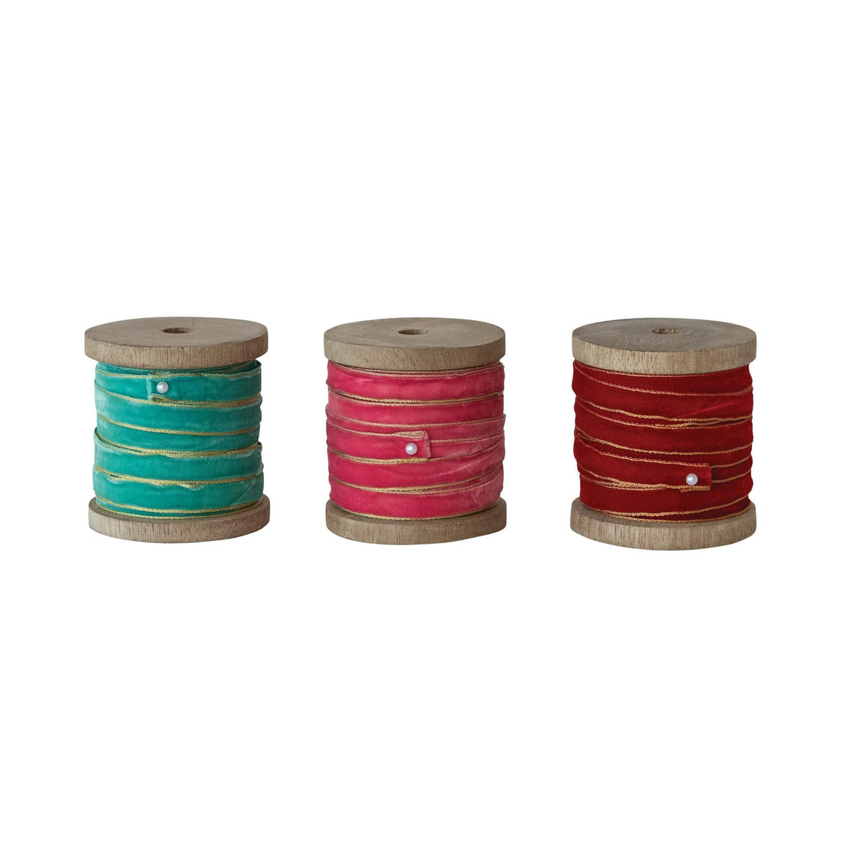Velvet ribbon with gold edges on wood spools in teal, pink, and red