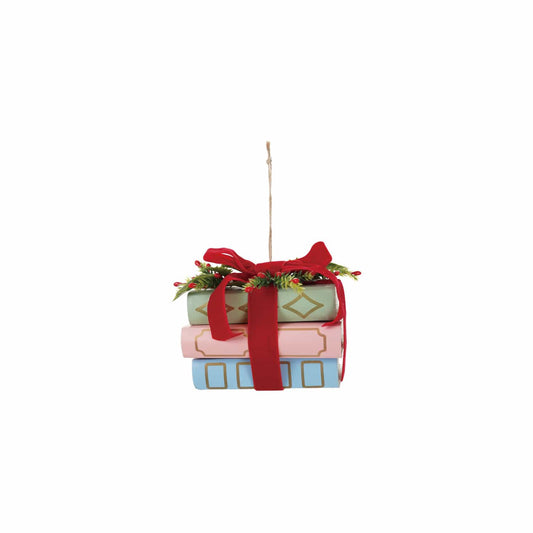 Stacked pastel paper books ornament with red velvet bow, holly, and gold details