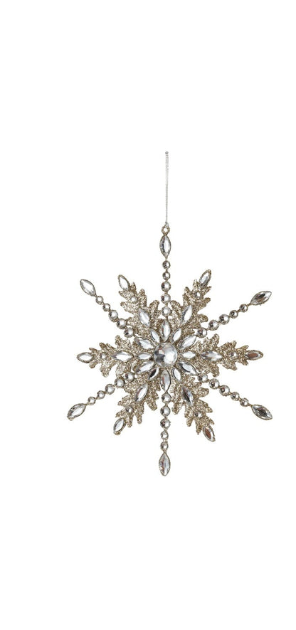 Gold glitter metal snowflake ornament with clear acrylic jewels on white background